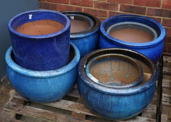 A group of eight modern garden pots, the largest, 50cm diameter x 30cm high (8).