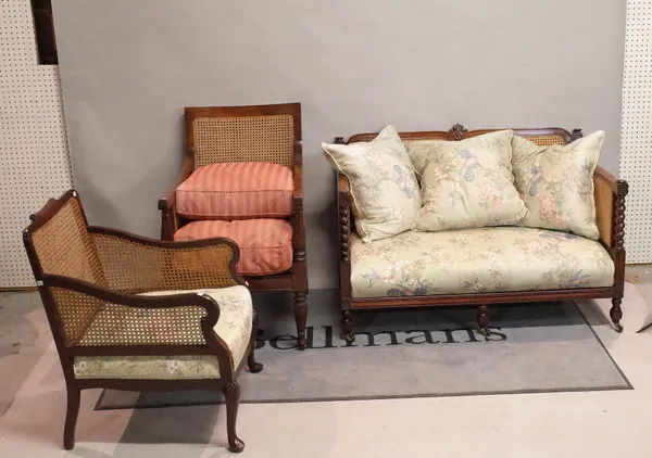 A late 19th century mahogany framed bergere sofa, 124cm wide, together with two differing bergere armchairs.
