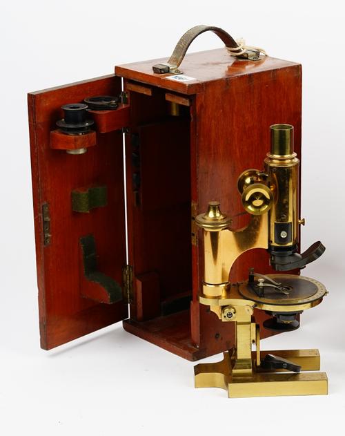 'Ross London',a late 19th century brass monocular microscope with rack and pinion focussing, single occular, contained in a mahogany case. microscope