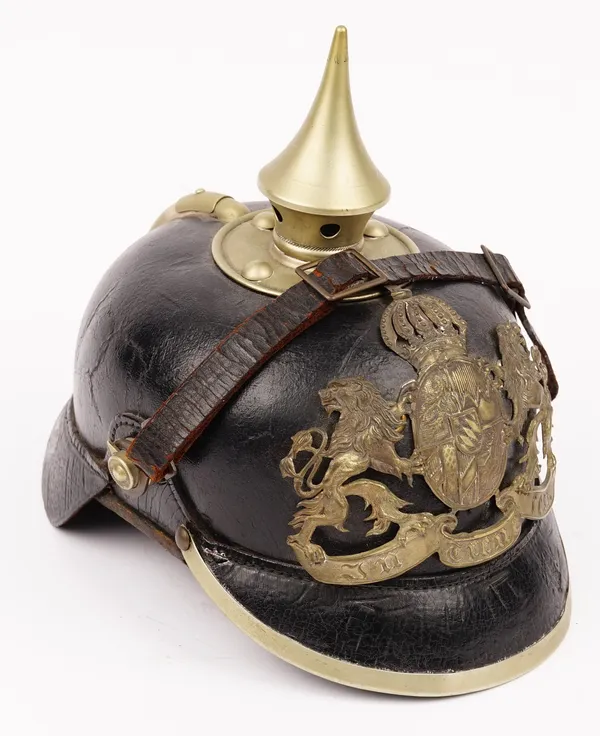 A Bavarian Pickelhaube mounted Bavarian state helmet, the flute to the centre with brass finial and leather chin strap, 24cm long x 16cm wide x 21cm h