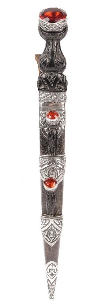 A Scottish dirk, early 20th century with polished steel blade, 23.5 cm, ornate thistle carved hard wood handle and large amber crystal to the pommel,