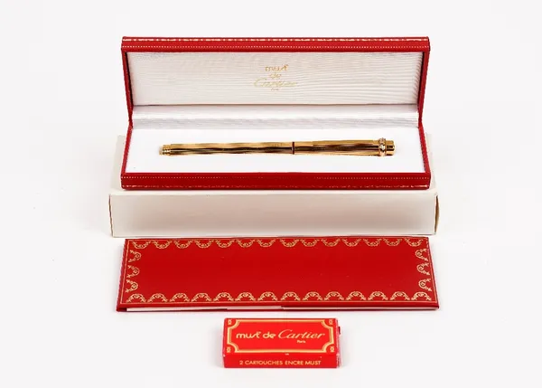 A Must de Cartier gold plated fountain pen, cased, with guarantee card and booklet.