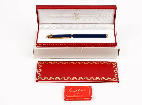 A Must de Cartier blue lacquered and gold plated fountain pen, cased with guarantee card and booklet.