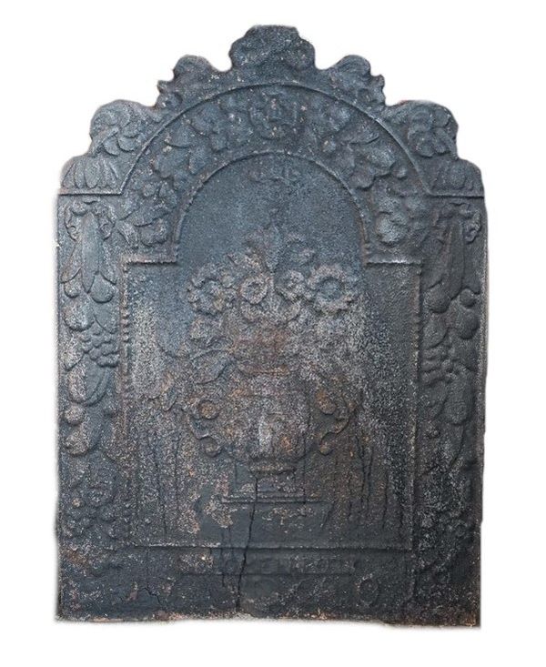 An 18th century cast iron fire back, relief cast with central flowers in a twin handled vase within a wide fruiting border, indistinctly detailed 'BLO