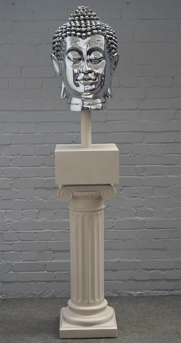 A modern silvered resin bust of a Buddha, raised on a square plinth with a white painted plaster Corinthian style column, combined height 206cm, (a.f.