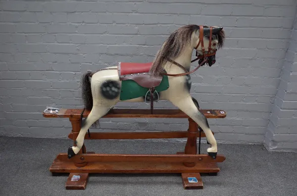 Haddon Rockers, a wooden painted rocking horse, with dapple grey body, on a stained pine base, 127cm long x 109cm high, (ears damaged).