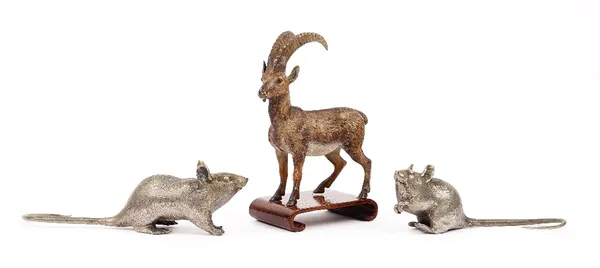 An Austrian cold painted bronze antelope, early 20th century, on a wooden stand, 11cm high, and two white metal models of rats, (3).