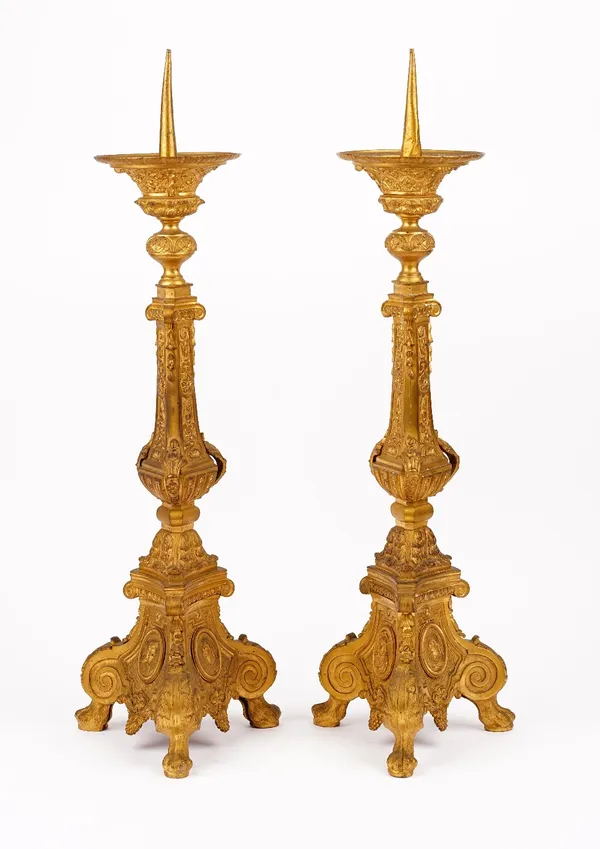 A pair of gilt metal pricket candlesticks, 20th century, resting on three lions paw feet, 63cm high.