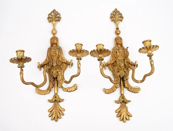 A pair of North European style giltwood twin branch wall sconces, each formed as an Egyptian figure, issuing serpent branches, 57cm high.