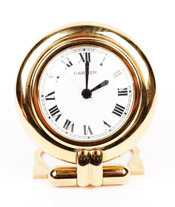 A Cartier 'colisee' quartz travel alarm clock, circa 1998, white dial with Roman numerals, to a gilt metal case with folding stand, with original Cart