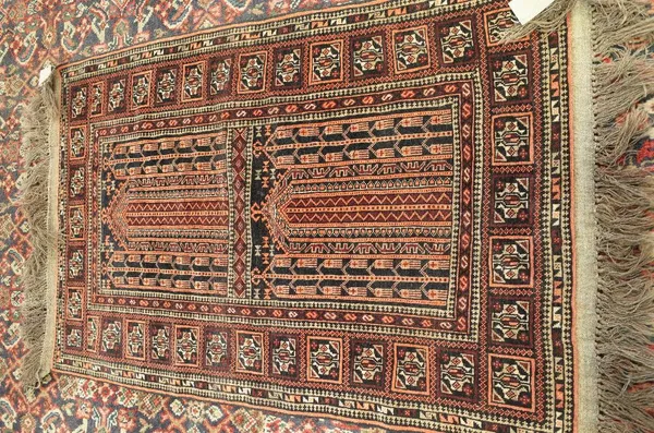 A Belouche prayer rug, the field with two mehrabs, a square-sectioned border, 140cm x 91cm.