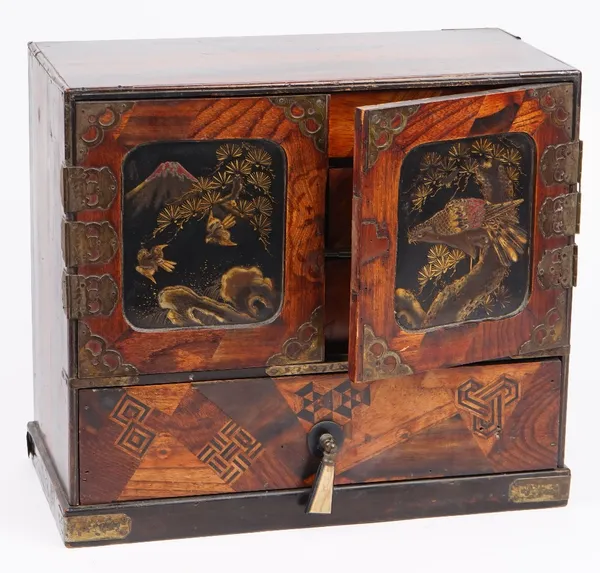 An early 20th century Japanese lacquer and specimen wood table cabinet, with an arrangement of cupboards and drawers on plinth base, 36cm wide x 32cm