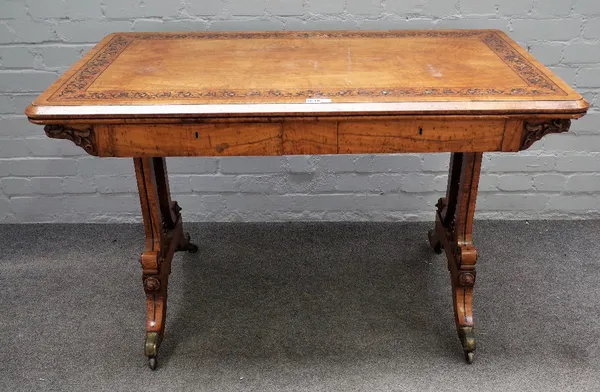 In the manner of Holland and Sons; a  Victorian floral marquetry inlaid amboyna banded olive wood rectangular two drawer writing table, on fret pierce