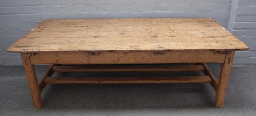 A 19th century Continental pine coffee table, with plank top and end frieze drawers, on reduced canted square supports, 76cm wide x 170cm long.