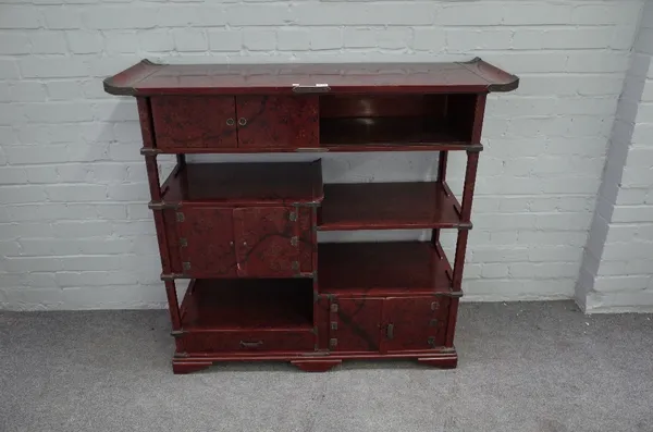 An early 20th century Japanese scarlet lacquered metal mounted side cabinet, with various shelves and cupboards, 114cm wide x 104cm high.