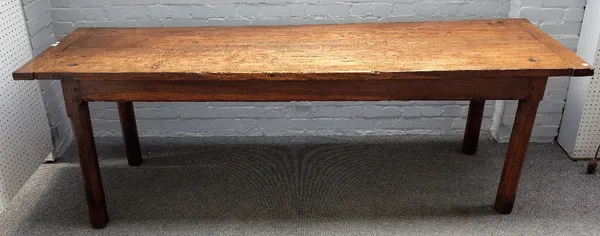 A 19th century oak kitchen table, with cleated twin plank top on canted square supports, 63cm wide x 230cm long.