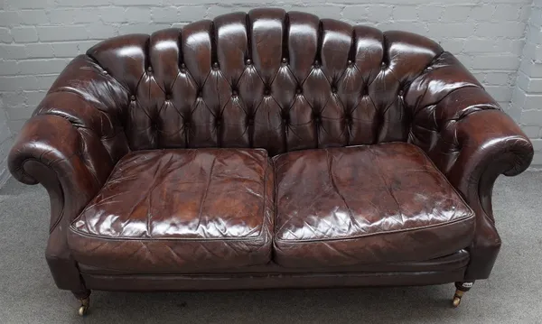 A Victorian style button upholstered brown leather hump back Chesterfield style sofa, on turned supports, 163cm wide x 85cm high.