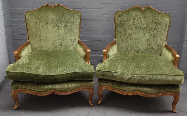 Duresta; a pair of Louis XV style armchairs, the gold painted frame with double hump back and serpentine seat on scroll supports, 90cm wide x 106cm hi