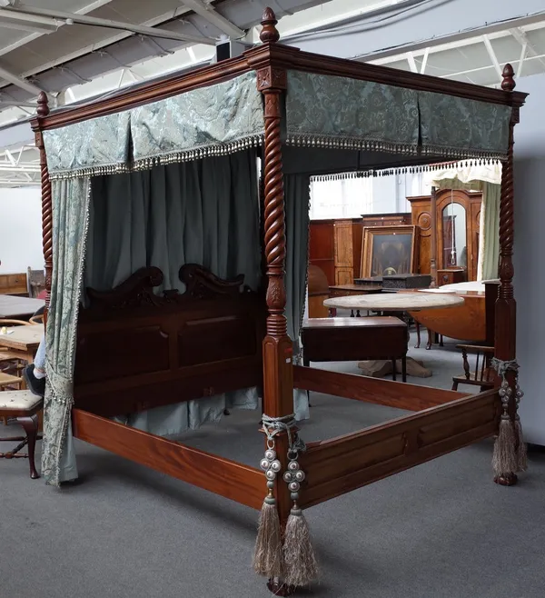 A contemporary carved mahogany four poster bed, in George III style, with palmette carved, ropetwist and ring turned square section columns, broken sw