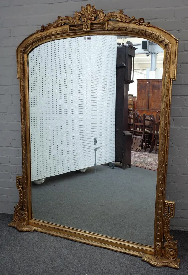 A Victorian style gilt framed arch top overmantel mirror with acanthus scroll crest, 146cm wide x 179cm high.