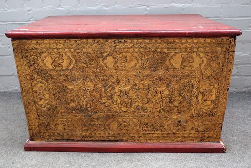 A Thai painted and gilded chest, with hinged top, the front and sides with panels of deities, 92cm wide x 61cm deep x 55.5cm high.