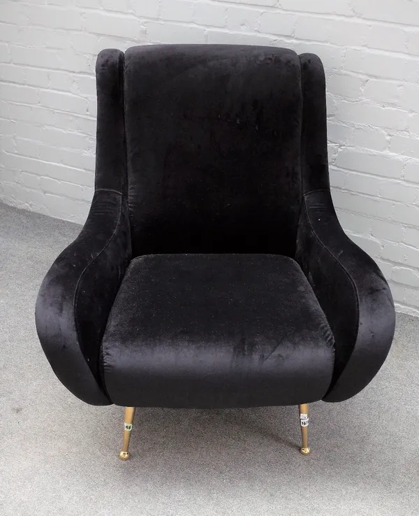 A retro design black faux suede upholstered easy armchair, on tubular lacquered brass supports, 85cm wide x 93cm high.