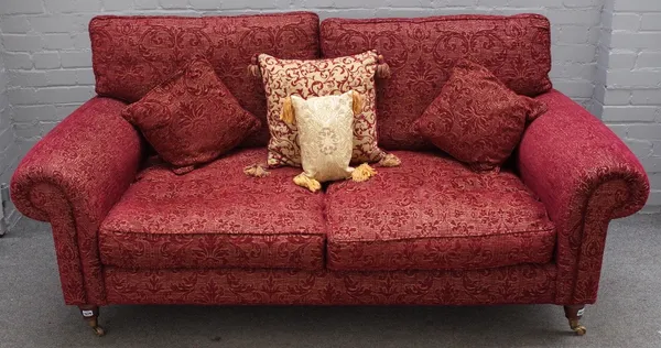 A modern roll arm sofa in patterned red upholstery on turned supports, 193cm wide x 83cm high.