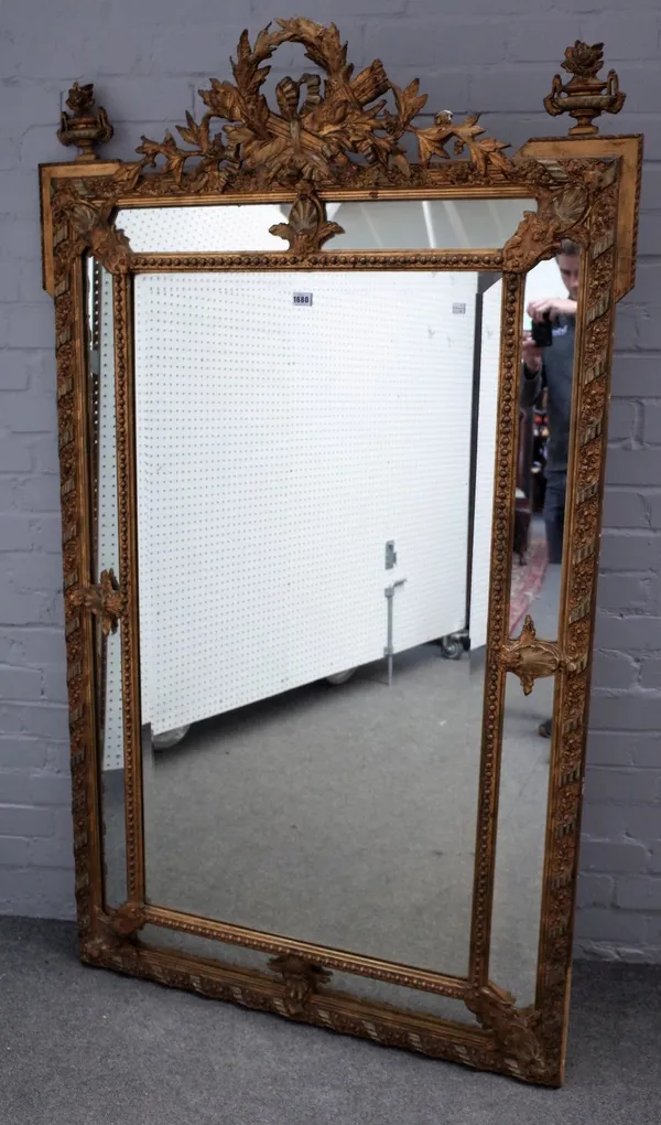 A 19th century French gilt framed marginal cushion mirror, with arrow quiver and flaming torch crest, 103cm wide x 173cm high.