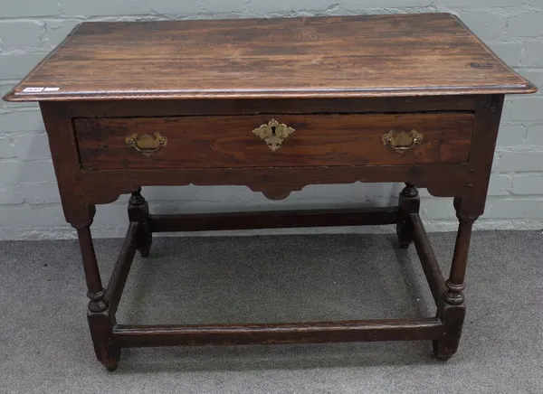 A late 17th century oak lowboy, the moulded rectangular top above a frieze drawer, on turned legs united by stretchers, 94cm wide x 55cm deep x 66.5cm