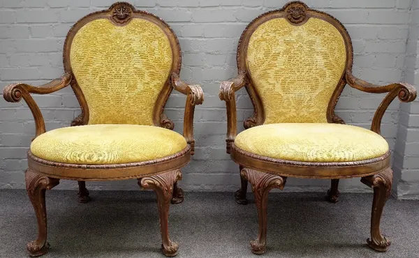 After Alexander Peter, a pair of George II style gilt framed open armchairs, 85cm wide x 109cm high.Provenance: This is two of ten chairs made to matc