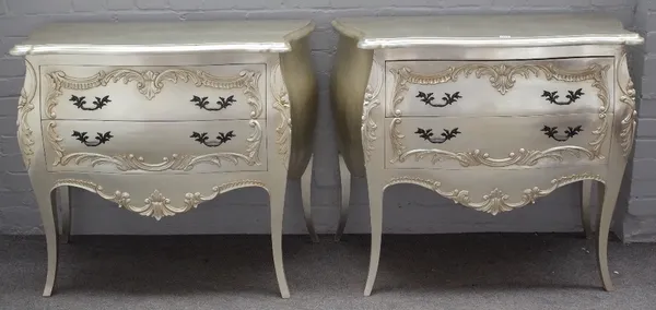 A pair of 18th century French style silver painted bombe two drawer chests, on outswept supports, 103cm wide x 87cm high, (2).