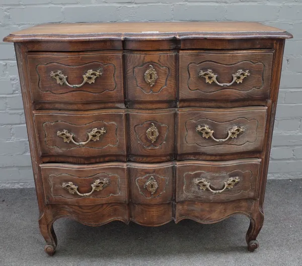 An 18th century style Continental oak chest with three long serpentine drawers, on scroll feet, 90cm wide x 84cm high.