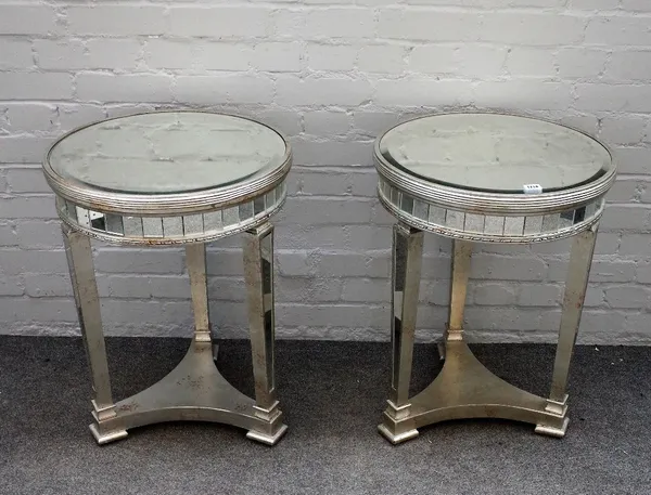 A pair of modern mirror veneered circular occasional tables, on tapering square supports, united by a concave platform, 49cm diameter x 68cm high, (2)