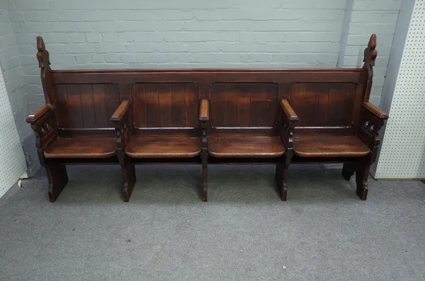 An oak Gothic Revival four seat church pew with pierced trefoil decoration, 240cm wide x 116cm high.