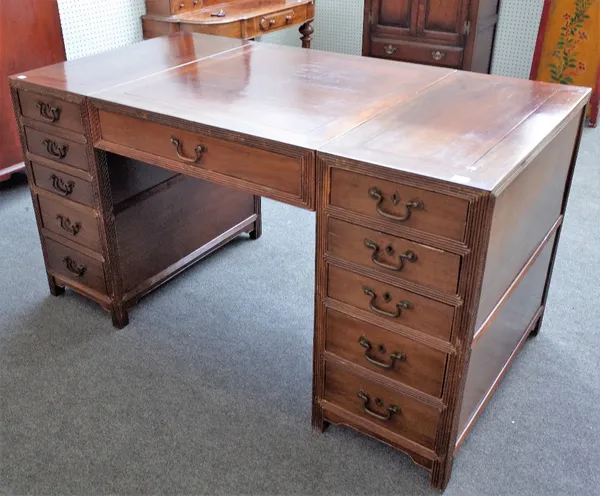 A Chinese hardwood desk, 20th century, with three frieze and eight pedestal drawers around the kneehole, 155cm wide x 82cm deep x 83cm high.