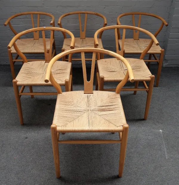 After Hans J Wegner, a set of six wishbone design beech framed dining chairs, 57cm wide x 77cm high.