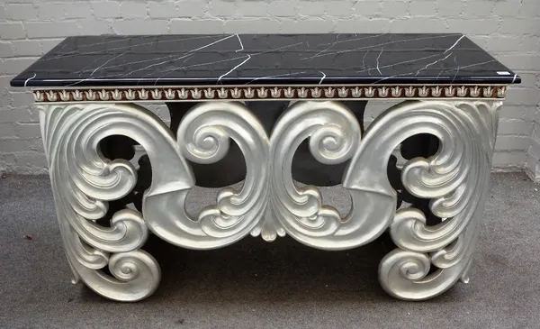 A modern console table, the faux rectangular marble top over a silver painted base of bold acanthus scrolls, 138cm wide x 79cm high.