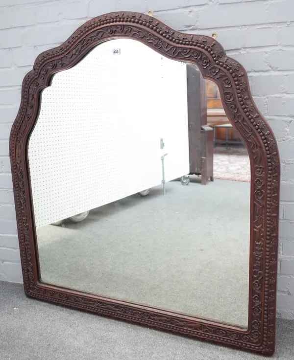 A 19th century Eastern hardwood arch top mirror, with foliate chased frame, 112cm wide x 123cm high.