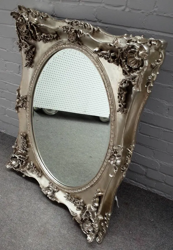 Laura Ashley, a pair of silver painted mirrors, with foliate moulded frames about the bevelled oval mirror plates, 85cm wide x 103cm high, (2).