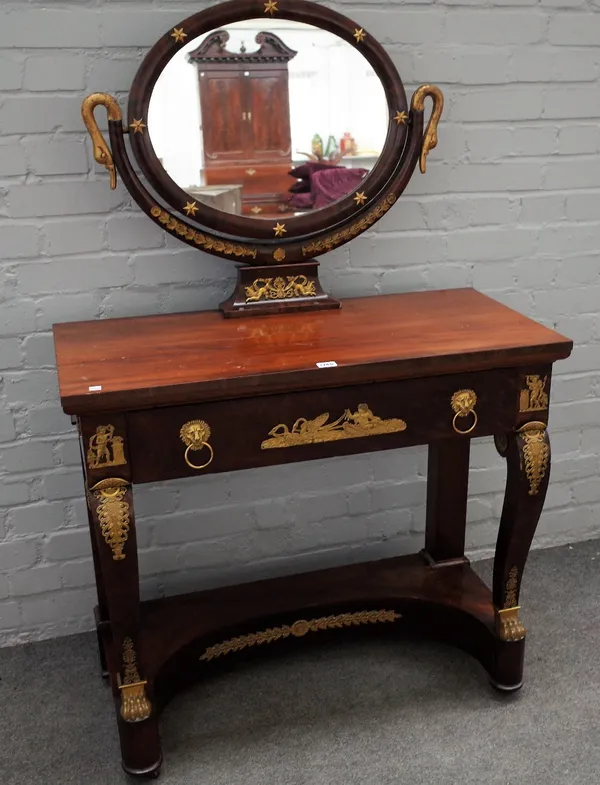 An Empire ormolu moulded mahogany dressing table, with oval mirror and single drawer on scroll supports, 89cm wide x 138cm high.