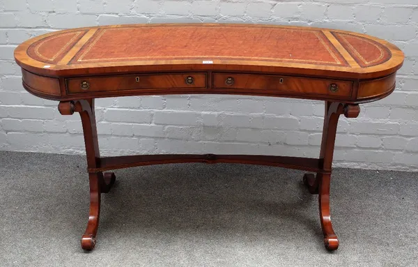 Possibly Brights of Nettlebed, a George III style kidney shaped mahogany two drawer writing table, on four downswept supports, 138cm wide x 75cm high.