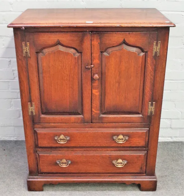 A small 17th century style oak side cupboard, by Titchmarsh & Goodwin, the pair of arch panel doors over two drawers, on bracket feet, 82cm wide x 102