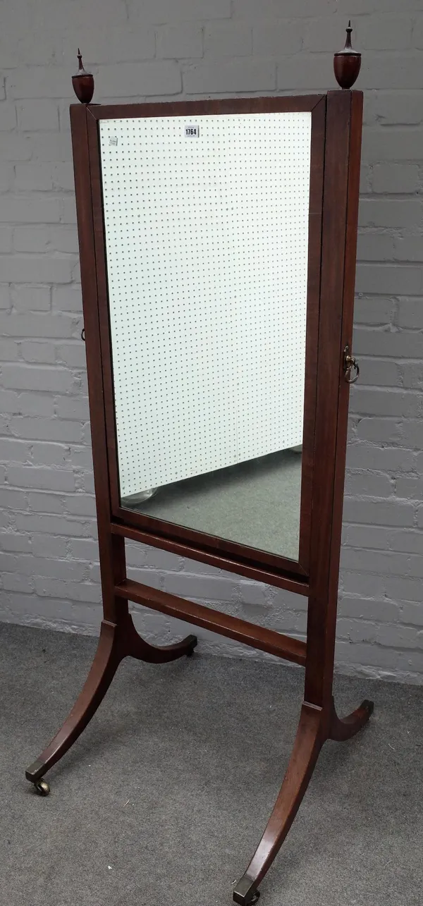 A George III mahogany cheval mirror, with urn finials on four downswept supports, 68cm wide x 167cm high.