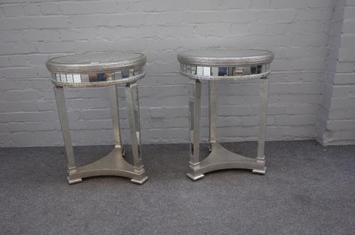 A pair of modern mirror veneered circular occasional tables, on tapering square supports, united by a concave platform, 49cm diameter x 68cm high, (2)