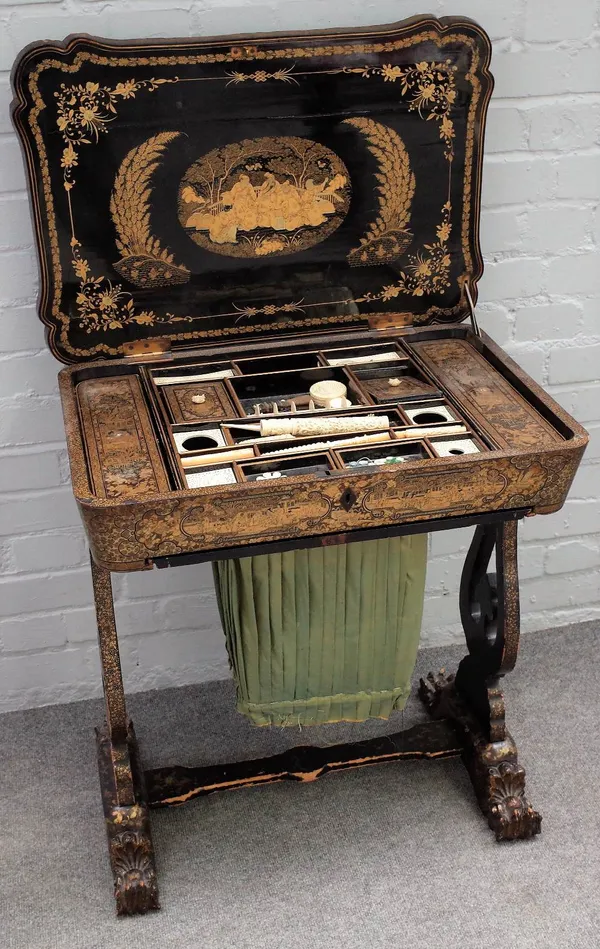 A Regency Chinese export black lacquer chinoiserie decorated sewing box, with fitted interior, on pierced trestle supports, 65cm wide x 72cm high.