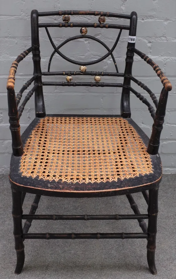 A Regency ebonised and parcel gilt faux bamboo open armchair, on splayed supports, 47cm wide x 78cm high.