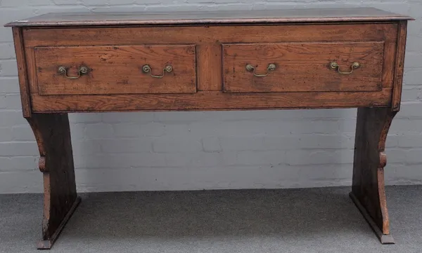 An 18th century elm and oak dresser, possibly West Country, with four frieze drawers on slab trestle supports, 143cm wide x 88cm high.