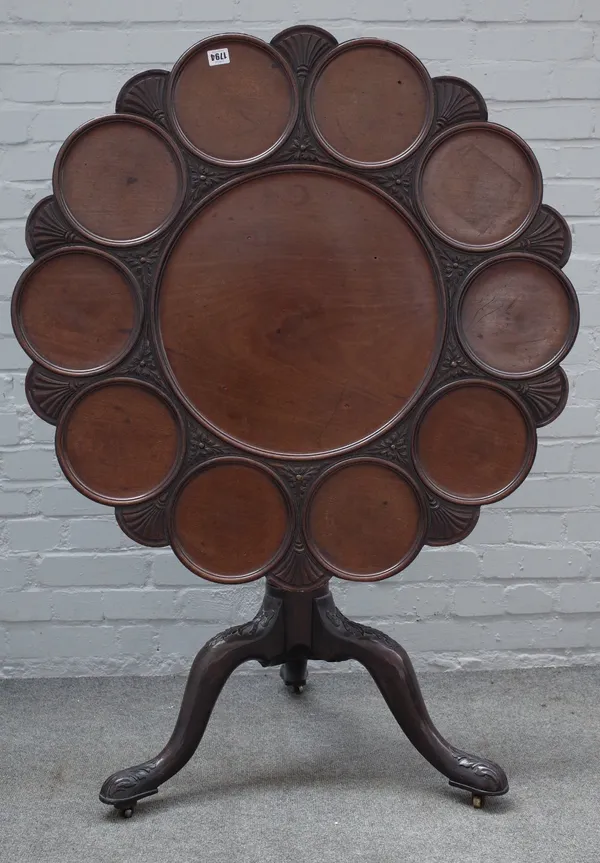 A mid-18th century style mahogany supper table, 19th century, the carved dished shaped circular tilt-top, on a whorled pillar and ribbon carved foliat