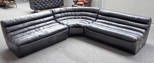 A modern black leather upholstered corner sofa, with ribbed design, 75cm high x 275cm x 275cm.