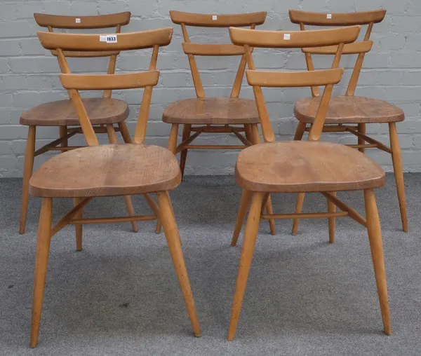 Ercol; a set of five beech and elm green dot stacking chairs, 39cm wide x 76cm high.